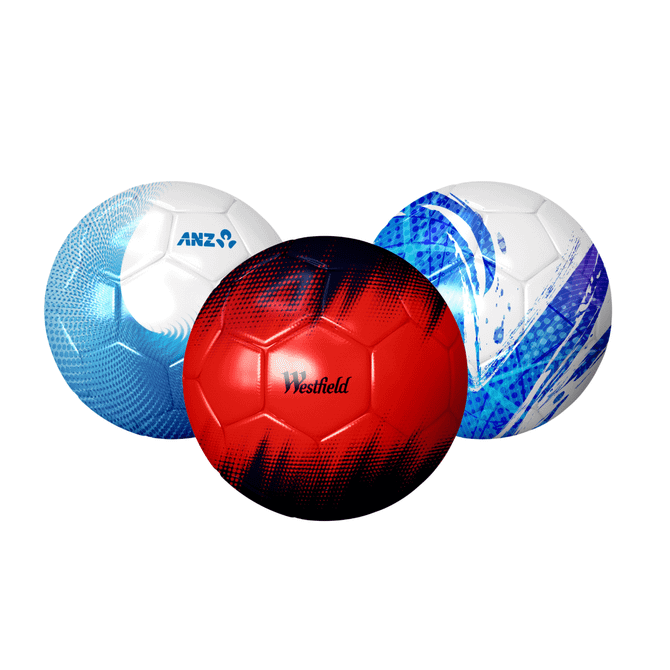 Three soccer balls in various designs: one blue, one red with a graphic pattern, and one white with blue accents, all featuring logos.