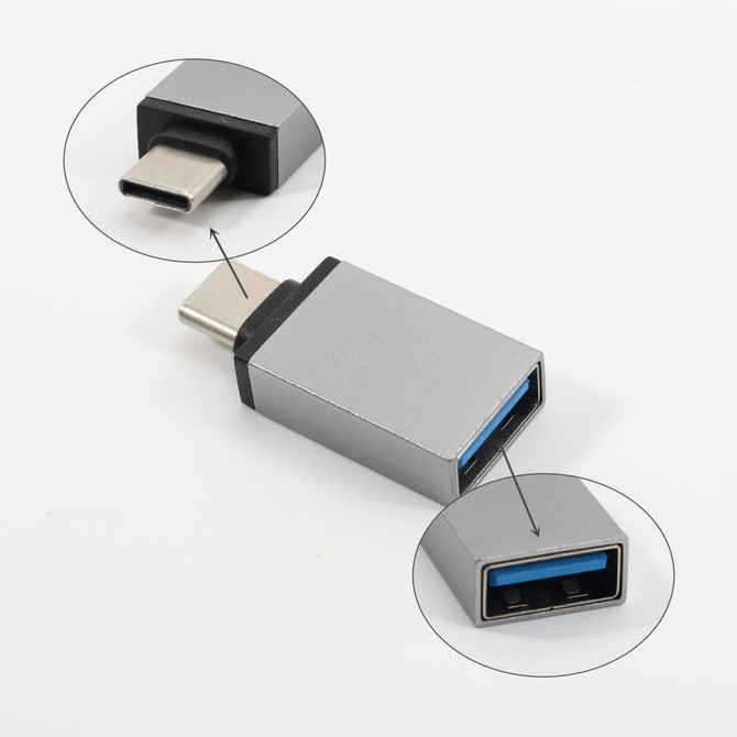 A silver USB data blocker with a USB-C connector on one end and a standard USB port on the other.