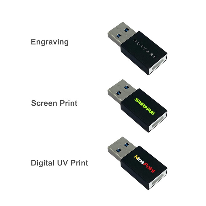 A collection of three USB drives in black, featuring different printing styles and designs. They all have branding on them.