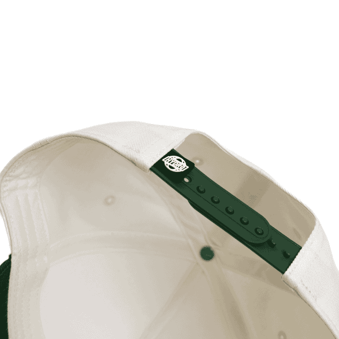 A two-tone cap featuring a cream interior and a green exterior, equipped with an adjustable snap closure.