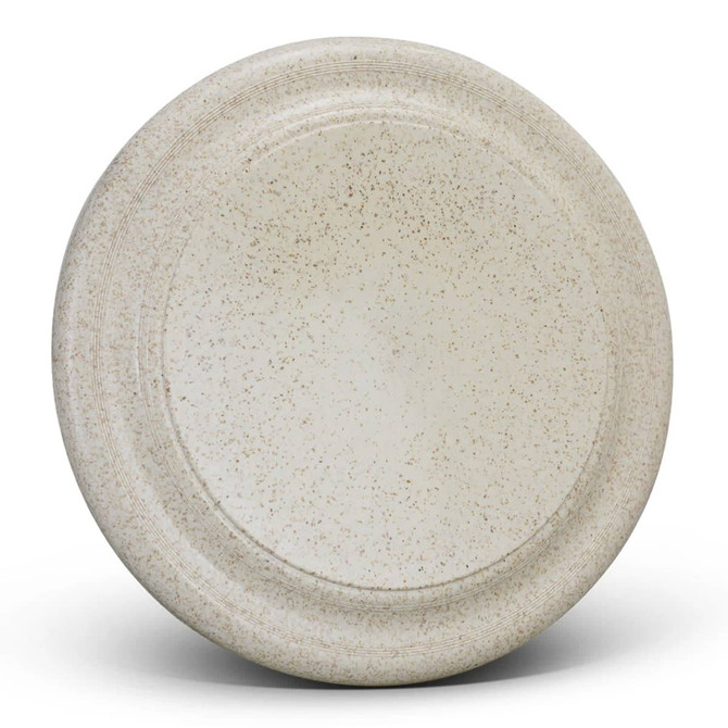 A large, speckled beige plate with a smooth surface and a raised edge, featuring a subtle logo.