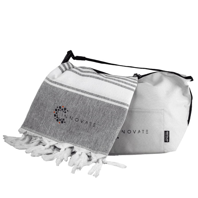 A grey and white towel with tassels alongside a grey cooler bag, both featuring a logo.