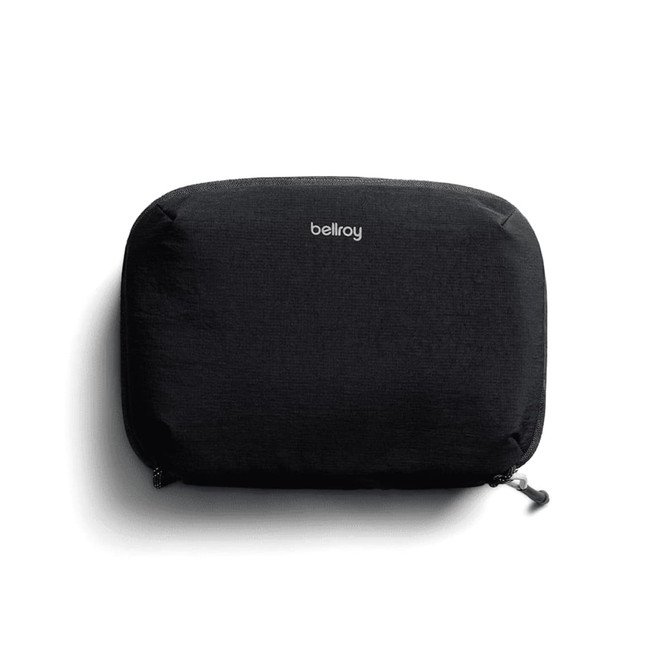 A black tech kit with a zip closure and a logo on the front, featuring a sleek, minimalist design.