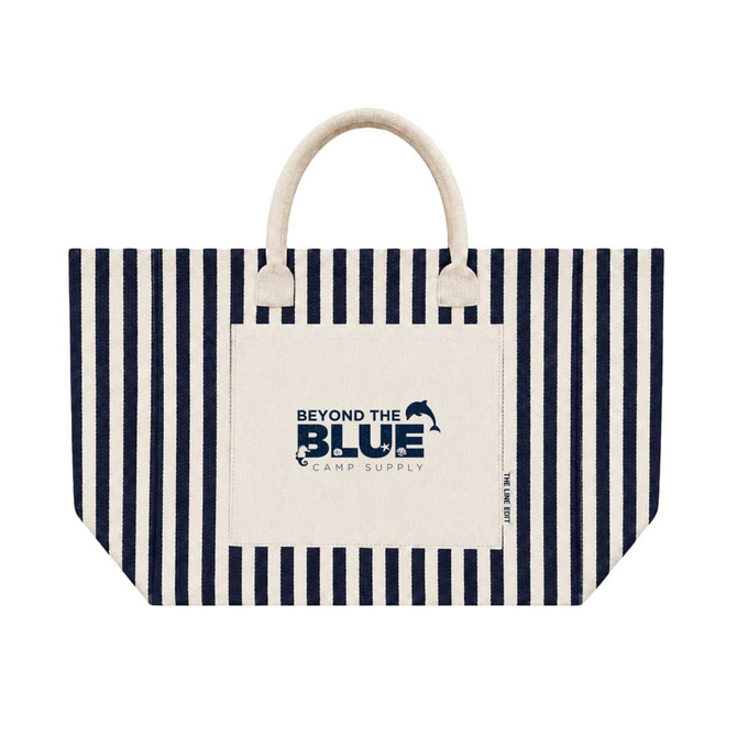 A striped navy and cream tote bag featuring a front pocket and handles, with a logo on the pocket.