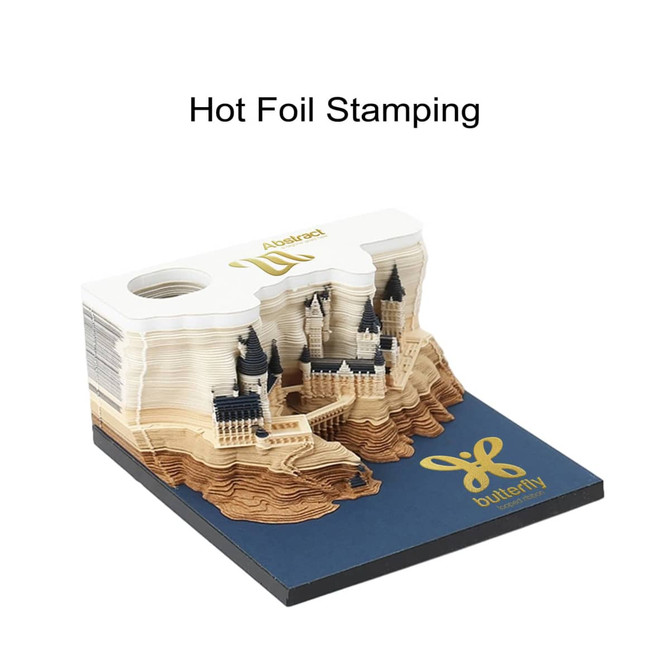 A 3D paper carving notepad in shades of beige and white, featuring intricate castle designs and a logo on the base.