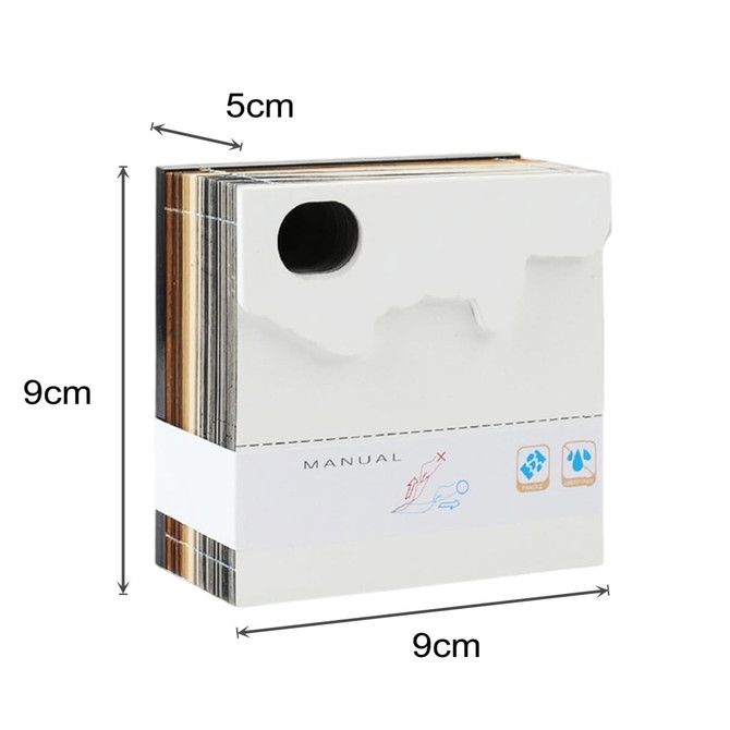 A 3D paper carving notepad in white, measuring 9cm x 9cm x 5cm, with a logo and a manual.