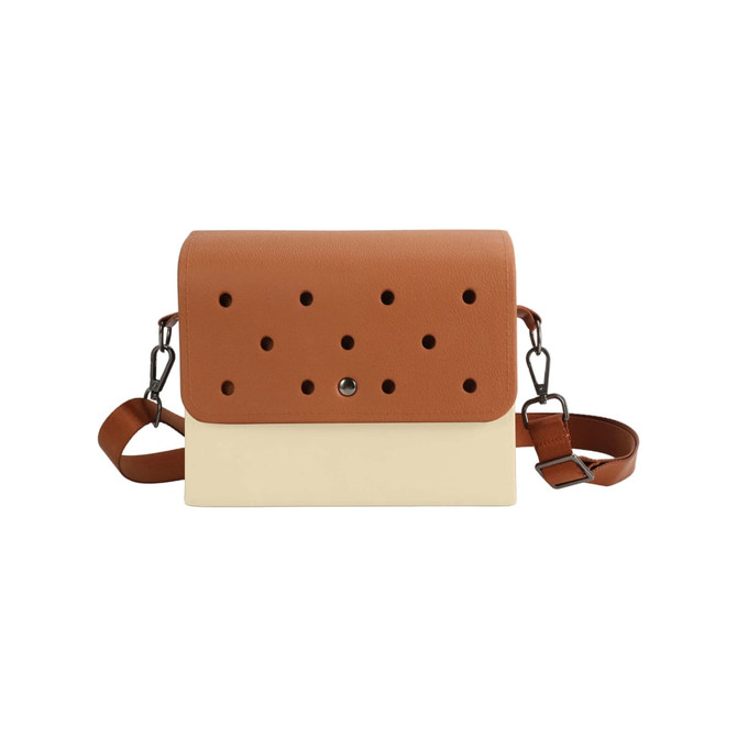A briefcase in tan and cream with perforated detailing and a detachable strap. It features a logo on the front.