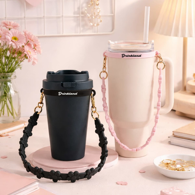 A drink bottle set featuring a black tumbler and a pink flower strap with a cream tumbler, both with logos.
