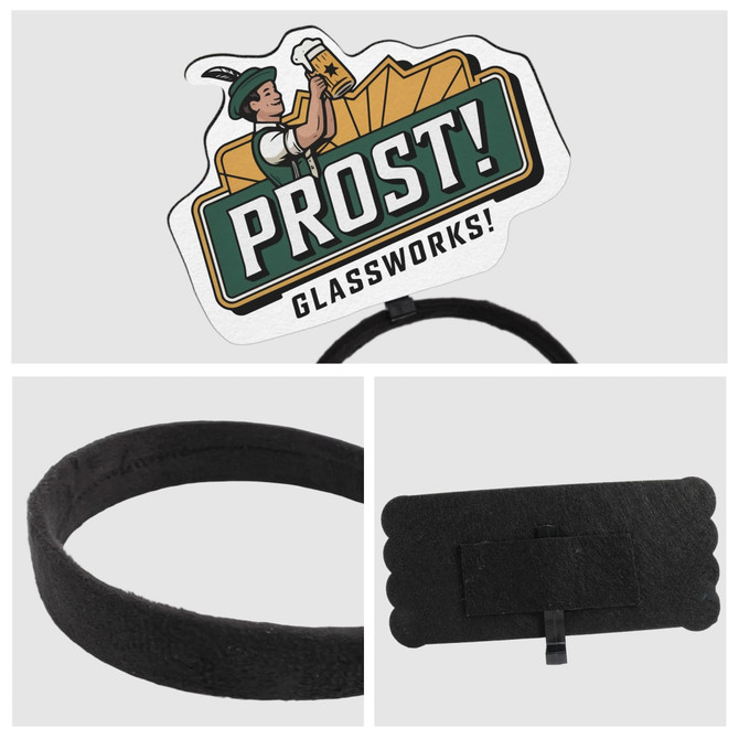 A black foam topper headband with a graphic design featuring a figure and text. The headband has a logo.