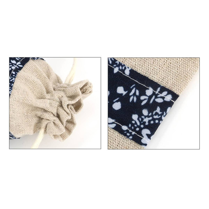 A cotton linen patchwork drawstring bag in beige and navy, featuring floral patterns and a gathered opening.