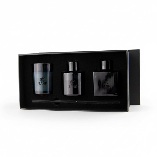 Aroma diffuser and candle gift box featuring a blue candle and two black diffuser bottles, all in a sleek black box with branding.