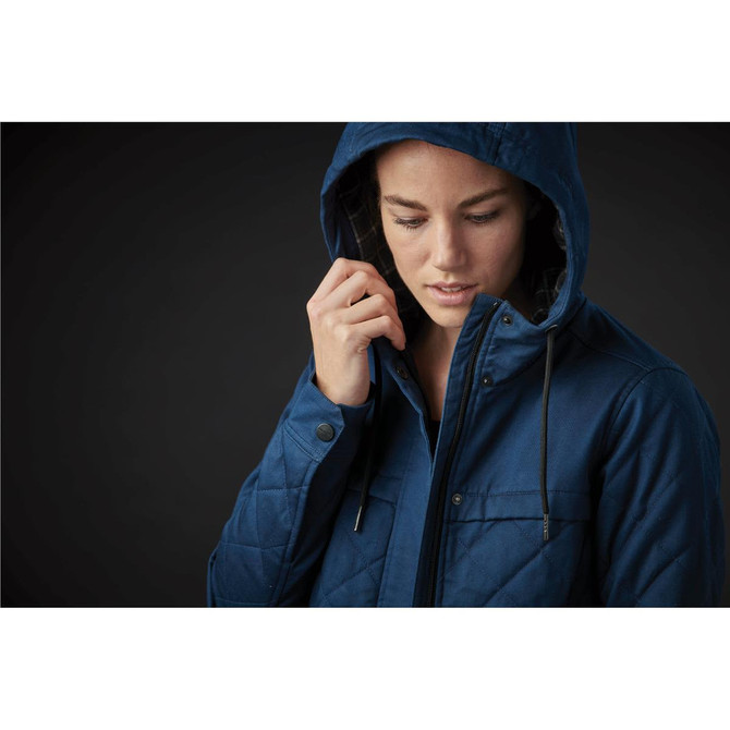 A women's blue quilted puffer jacket with a hood, featuring a zip and buttons, shown on a person.