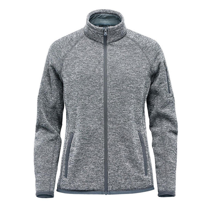 A women's full zip fleece jacket in grey, featuring a high collar and side pockets, with a logo on the sleeve.