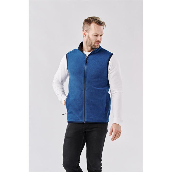 Men's Novarra Vest in blue, featuring a zip front and a logo, worn over a white long-sleeve shirt.