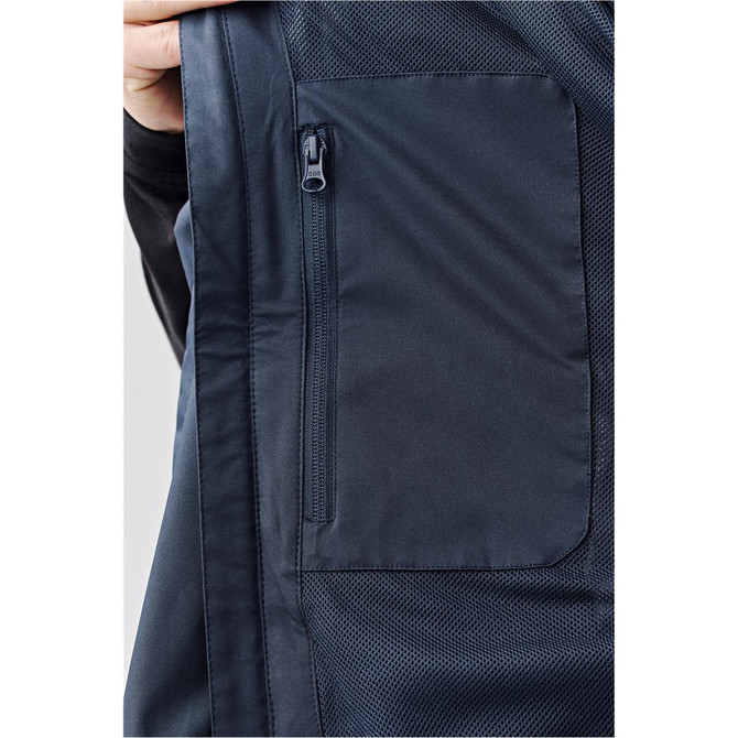 A close-up of a navy lightweight rain jacket featuring a zipped pocket and mesh detailing. It includes a logo.