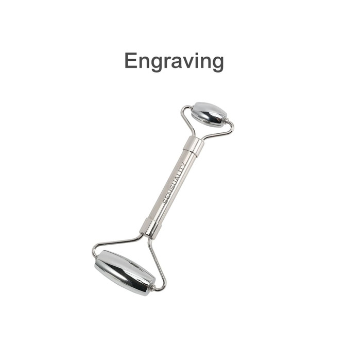 A stainless steel facial roller with two smooth ends and a central handle, featuring a logo.