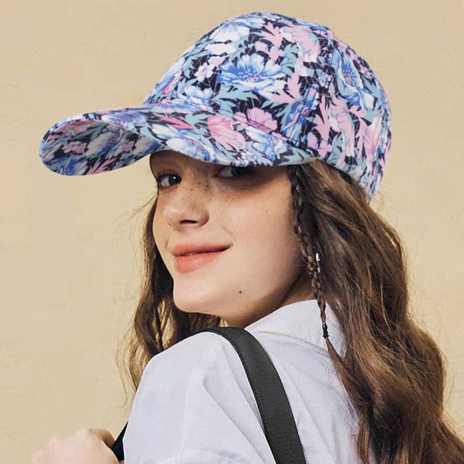 A floral-patterned 6 panel cap featuring shades of blue, pink, and purple, with a branding logo visible.