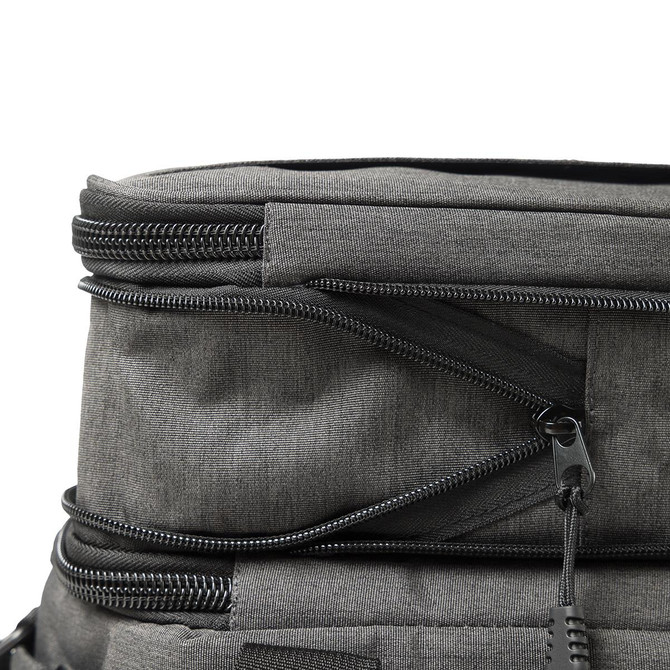 A grey expanding cooler with zippers and compartments for storage. Features a sleek, modern design.