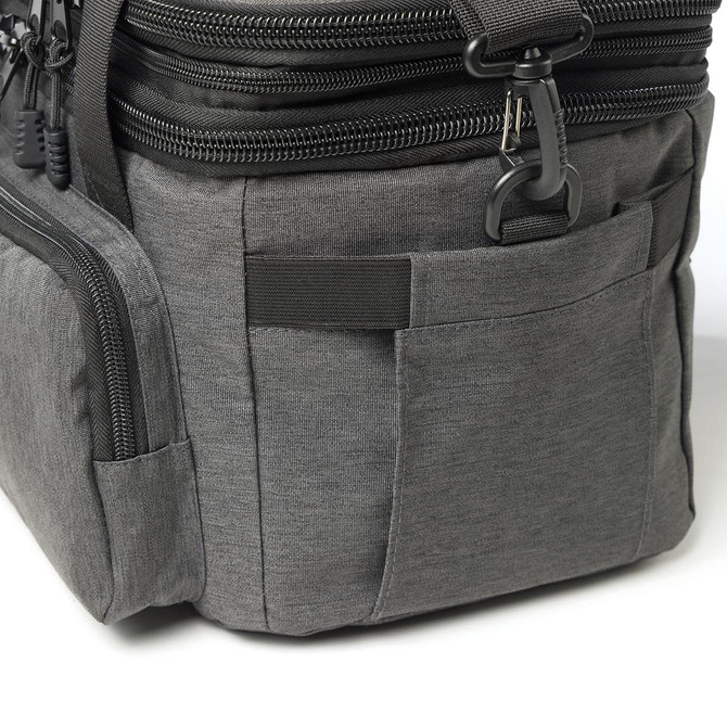 A grey cooler bag with multiple zippered compartments and pockets, featuring a logo on the side.