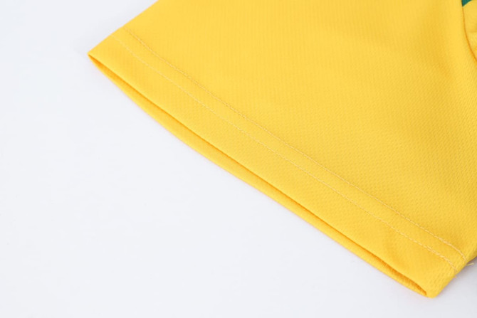 A close-up of a yellow polyester micro mesh sports long sleeve shirt, showcasing the fabric texture and sleeve detail.