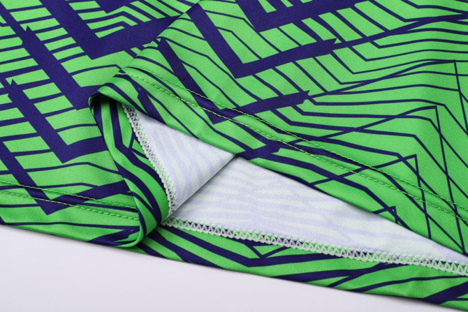 A vibrant green and navy patterned unisex long sleeve shirt featuring a V-neck design and soft fabric.