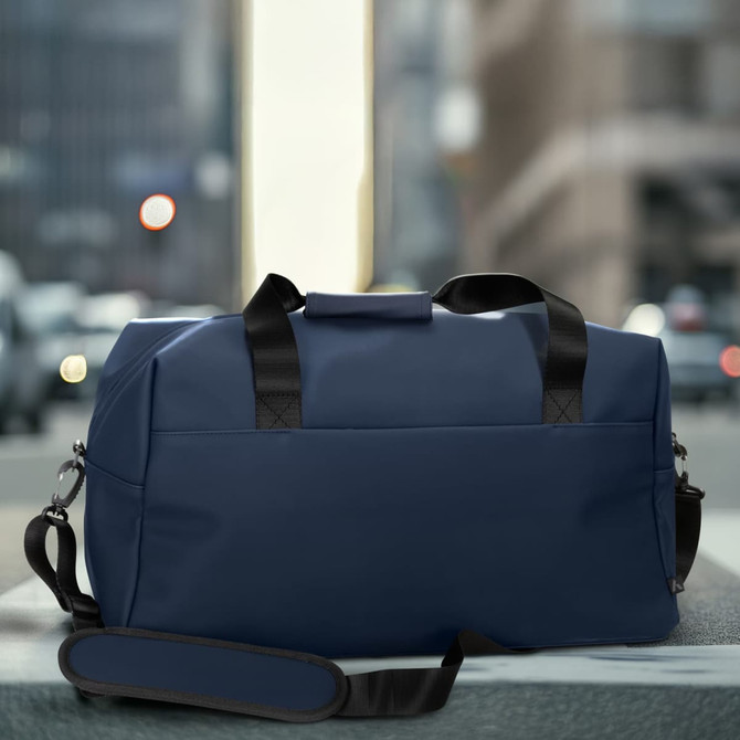 A navy blue soft-touch duffle bag with black handles and a shoulder strap, featuring a logo.