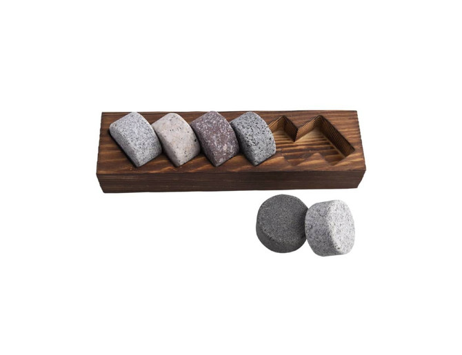 A wooden base holding six whisky discs in various shades of grey and brown, with two additional grey discs beside.