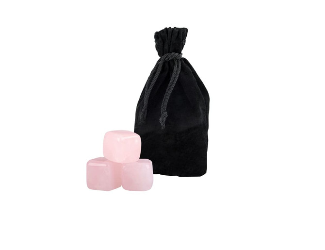 A black velvet bag contains six pink rose quartz gin stones, three stones visible in front.