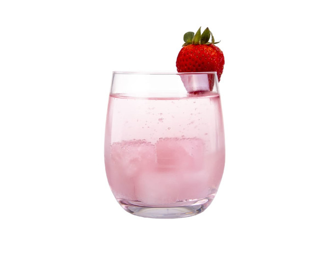 A glass of pink drink with ice cubes, topped with a fresh strawberry. The glass is clear and sleek.