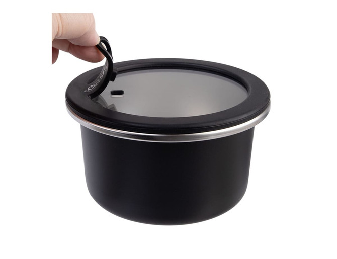 A round, black stainless steel container with a clear lid and a handle. Features a sleek design and reflects modern styling.