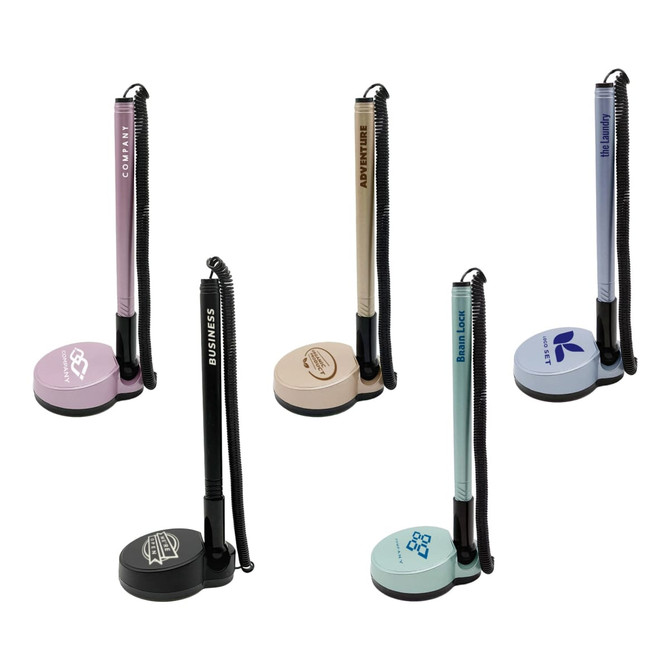 A set of five fixed signature pens on stands, featuring pastel colours like pink, beige, and blue, with various branding.