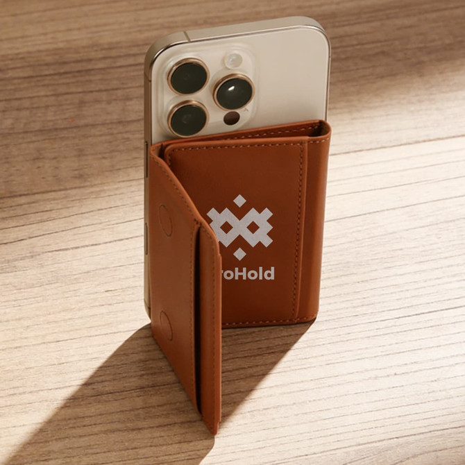 A brown PU magnetic wallet paired with a smartphone, set against a wooden surface. The wallet features a logo.