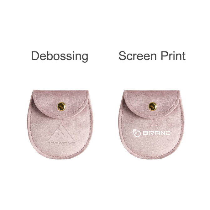 A pink oval velvet jewelry pouch with a button closure and branding options for debossing and screen printing.