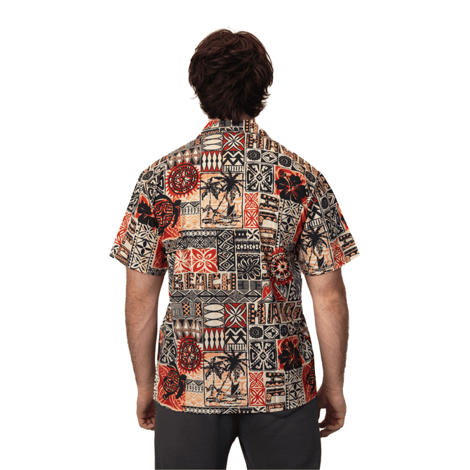 A patterned button-up shirt in earthy tones featuring various tribal designs and a logo on the back.