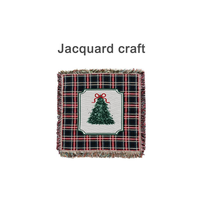 A Tapestry Blanket featuring a festive tree design surrounded by a plaid pattern in red and green with fringed edges.