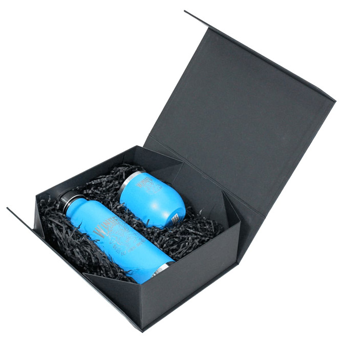 A black magnetic gift box containing two blue drink bottles nestled in black shredded paper.