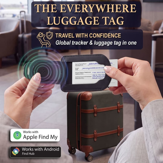 A luggage tag with a sleek black design, featuring a tracking device, is being held near a suitcase.