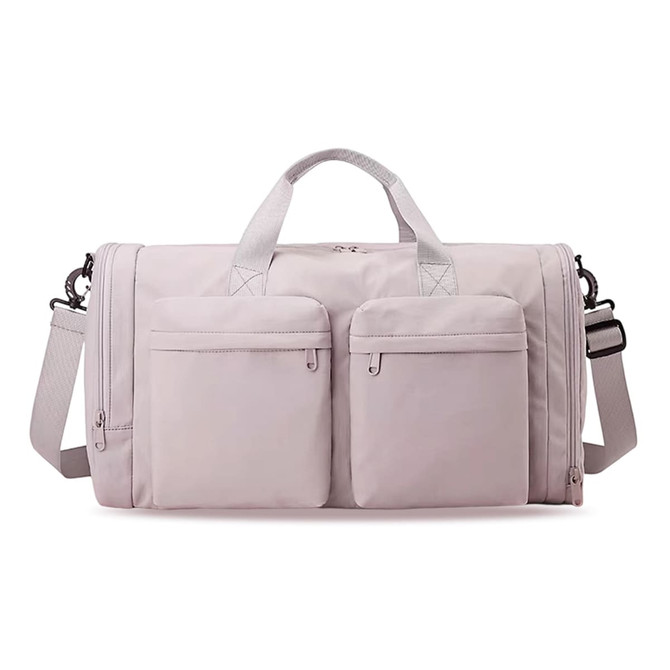 A foldable travel duffle bag in light pink with two front pockets and a shoulder strap. It also has a logo.