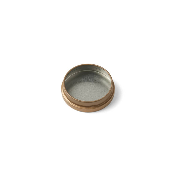 A small bronze tin candle with a shiny silver interior. The lid is slightly raised, revealing the empty interior.