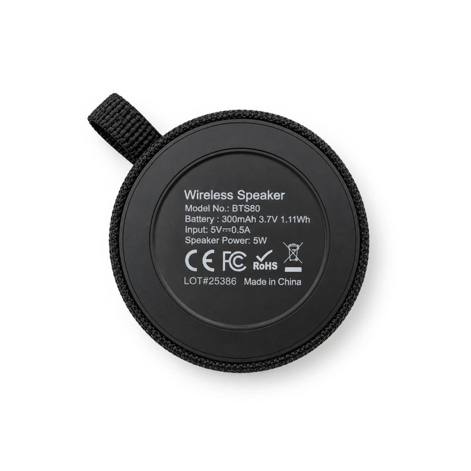 A round black wireless speaker with a textured surface and a hanging loop, featuring technical specifications on the back.