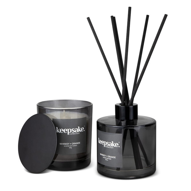 A black candle and diffuser set featuring a whisky and orange scent, with a sleek design and branding visible.