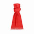 A red scarf with fringed edges, featuring a simple design and a soft texture. It has a logo on it.
