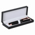 A pen set in a black box featuring two metallic pens with rose gold accents.