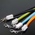 A set of TPE lanyard charging cables in black, lime green, blue, and orange, featuring clips and branding.