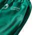 A close-up of unisex adult sports shorts in green, featuring a logo and a smooth polyester fabric.