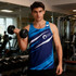 A blue and navy sports singlet featuring a logo, worn by a man holding a dumbbell in a gym setting.