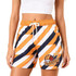 Women's board shorts in orange, navy, and white with a drawstring, pocket, and logo.
