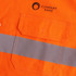 A bright orange long-sleeve shirt with reflective strips and a pocket, featuring a logo on the upper left.