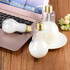 A drink bottle set featuring two bulb-shaped, clear plastic bottles with gold caps, containing white liquid.
