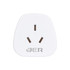 A white universal travel adapter with three prongs and a logo at the bottom.